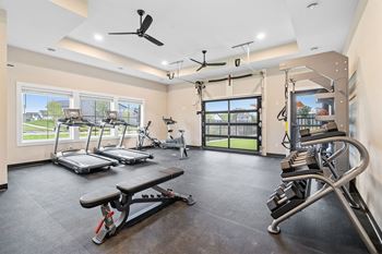 a gym with treadmills and other exercise equipment